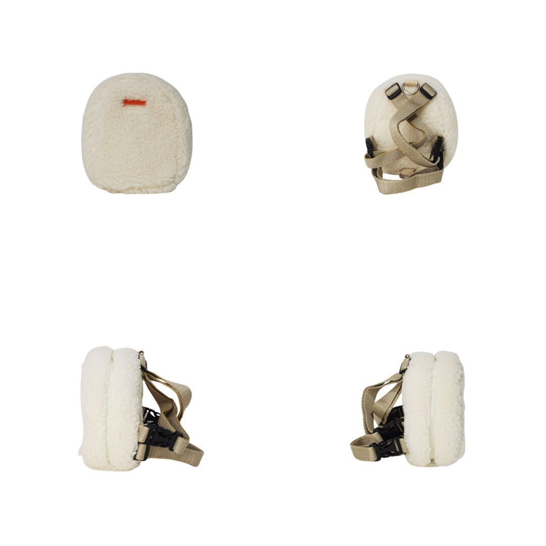 Finny Fur White model Ruffsack backpack at 4 angles including the front, back, side 1, and side 2.  The backpack features a furry, fluffy white fabric. A side zipper allows access to the inside. Straps are light tan in color.