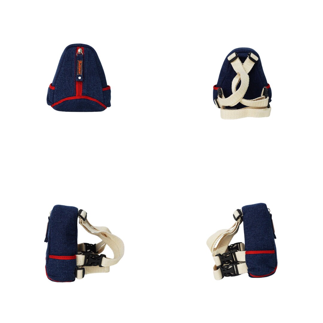 Lee model Ruffsack backpack at 4 angles including the front, back, side 1, and side 2. The backpack features a teardrop shape made with cotton blue jean style fabric with red accents along two side pockets and the center pocket. A vertical zipper down the center allows access to the inside. Straps are light tan in color.