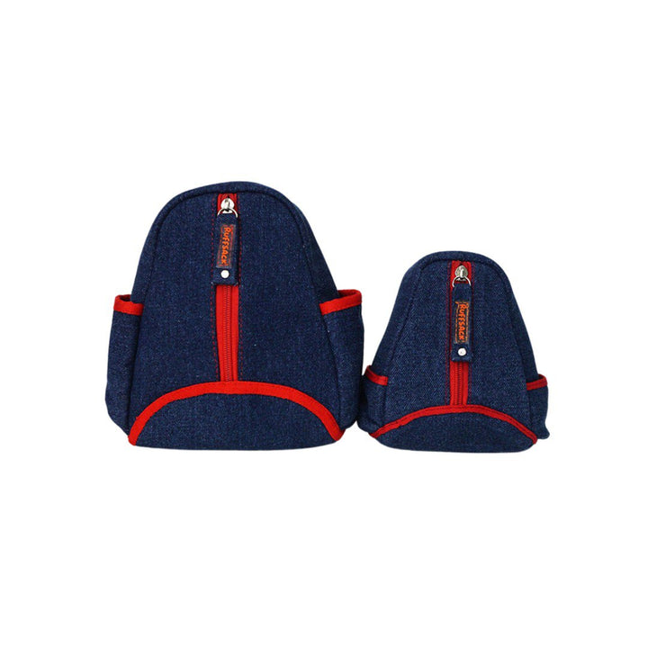 Lee model Ruffsack backpack front angle. The backpack features a teardrop shape made with cotton blue jean style fabric with red accents along two side pockets and the center pocket. A vertical zipper down the center allows access to the inside.
