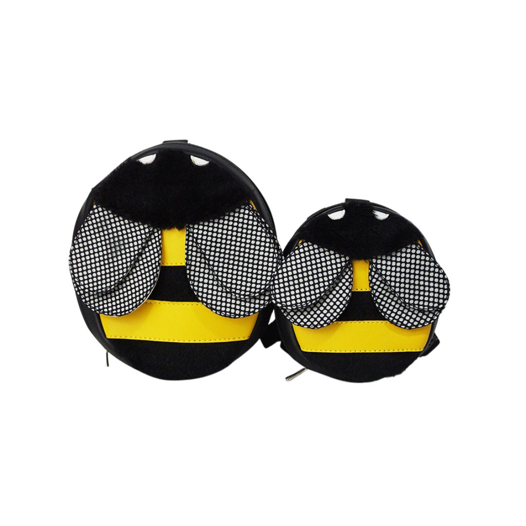 Bumble Bee model Ruffsack backpack front angle. The backpack features an oval bumble bee shape made with faux leather yellow stripes,  furry black stripes, textured wings, black head, and white eyes. A side zipper allows access to the inside.