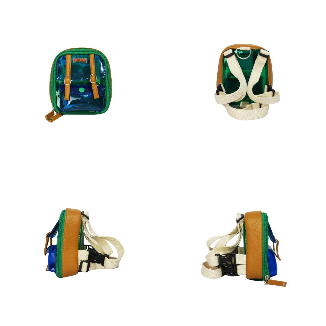 Jelly Dale, Green and Blue, model Ruffsack backpack at 4 angles including the front, back, side 1, and side 2. The backpack face features a transparent blue and green plastic with a small front buttoned pocket. Tan faux leather accents are on the front and sides of the bag. A side zipper allows access to the inside. Straps are light tan in color.